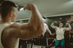 Sexy muscle man flexing in the gym
